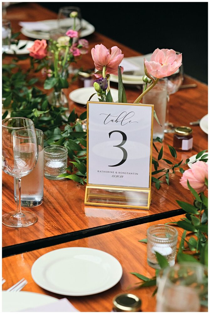 Table setting with floral centerpiece and Table 3 sign.