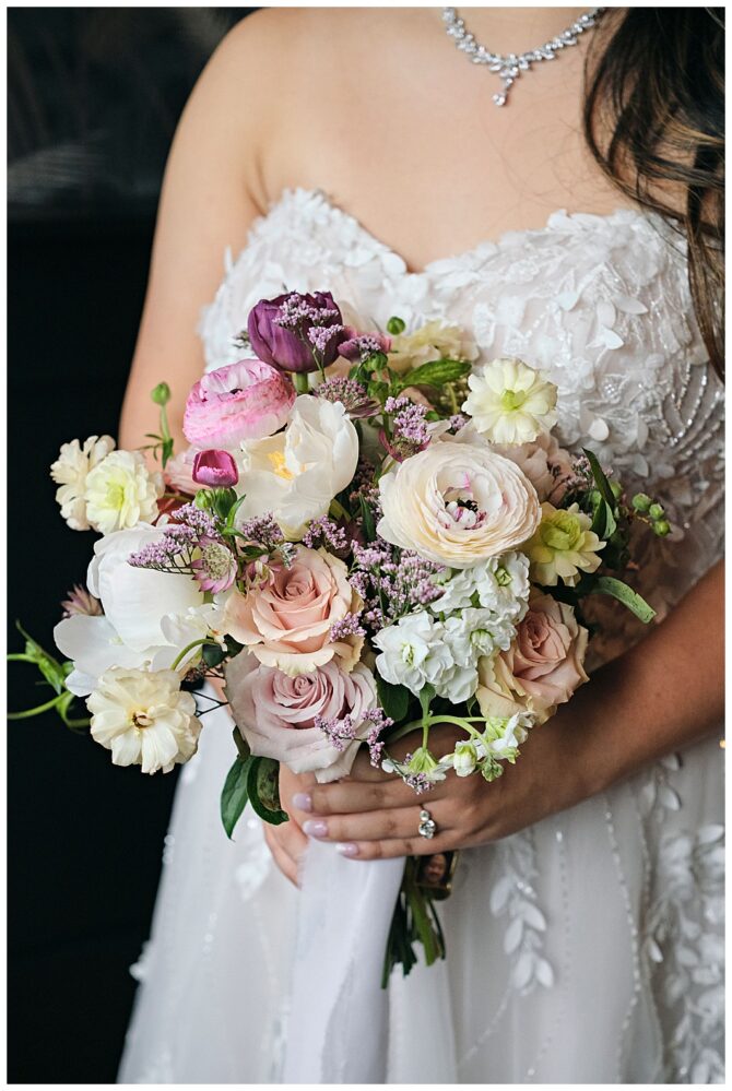 Bride holding colorful flower bouquet