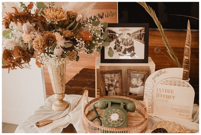 Vintage phone, flowers, family photos, and guestbook display.