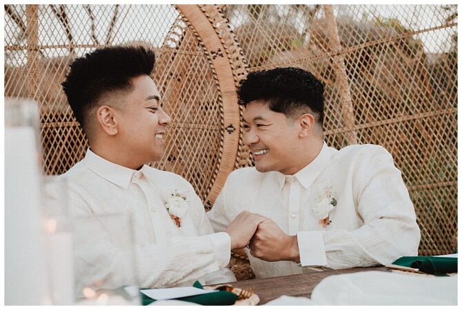 Smiling couple in white shirts holding hands