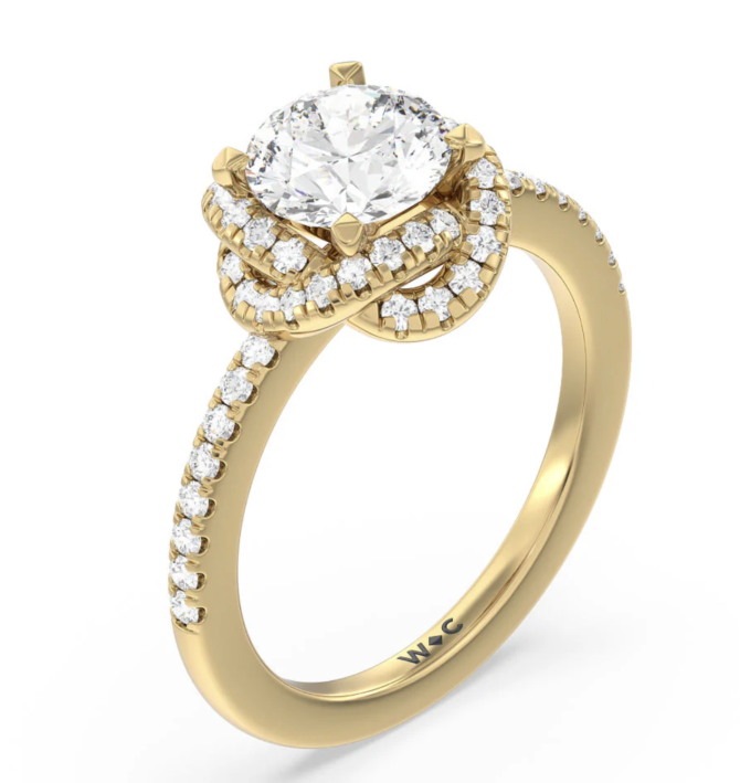 Gold engagement ring with diamond cluster design.