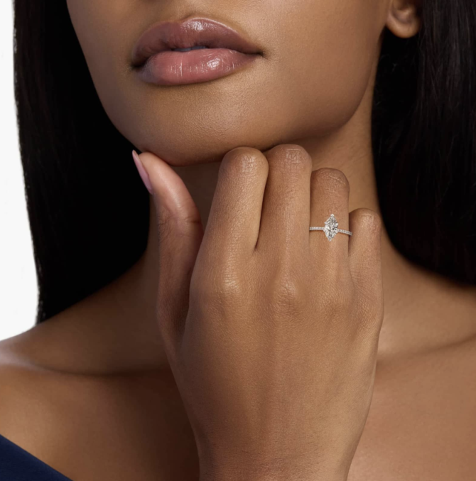 Woman's hand displaying diamond ring